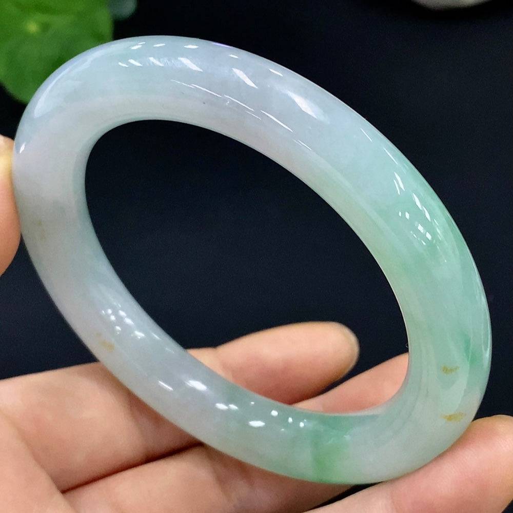 Huiliu Certified Jadeite round bangle showcasing smooth, polished green jade with a glossy finish.