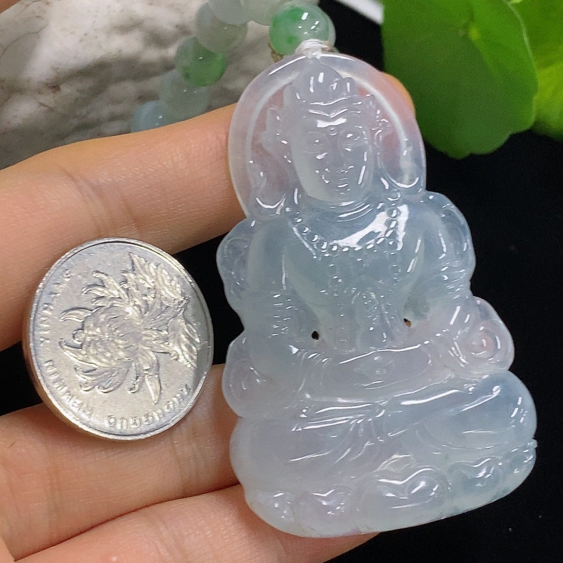 Jadeite Tara pendant from HKHQ featuring a smooth, polished jadeite jade pendant with intricate carved details.