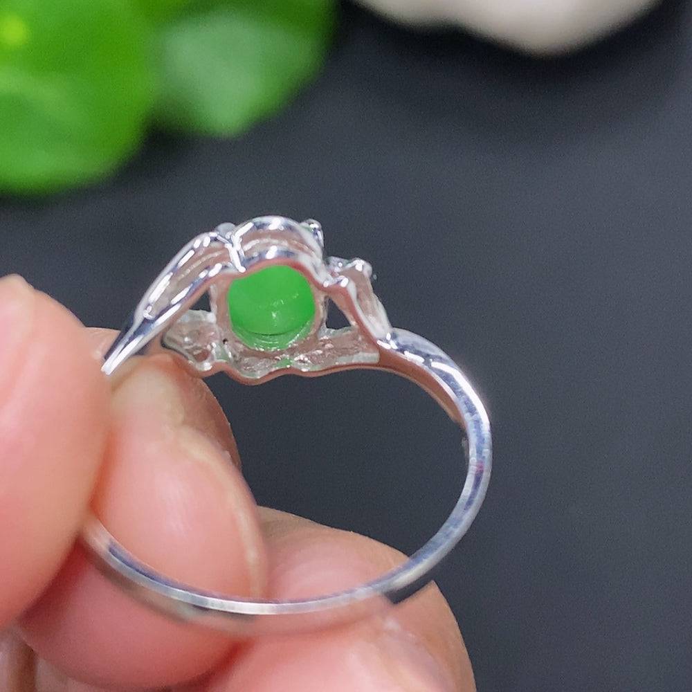 Huiliu HQ jadeite cabochon solitaire ring featuring a polished green jade stone on a silver band.