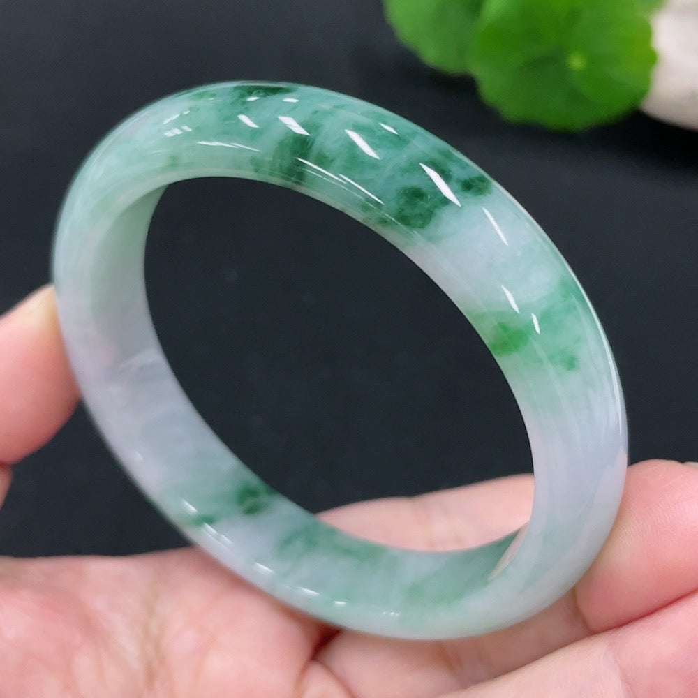 Huiliu certified jadeite round bangle showcasing smooth, polished green jade with natural translucency and rounded design.