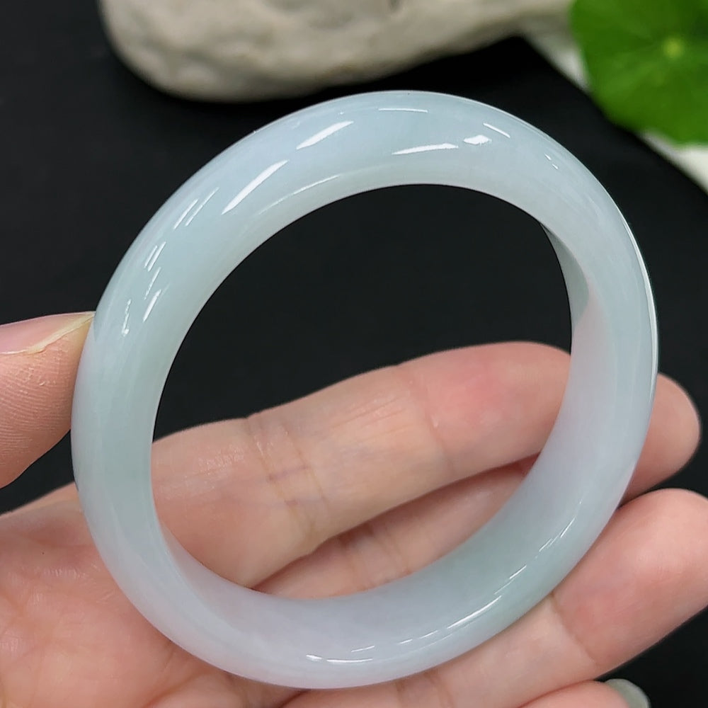 HKHQ jadeite oval bangle in size 54.6, weighing 44.9g, featuring smooth, polished green jadeite with a sleek oval shape.