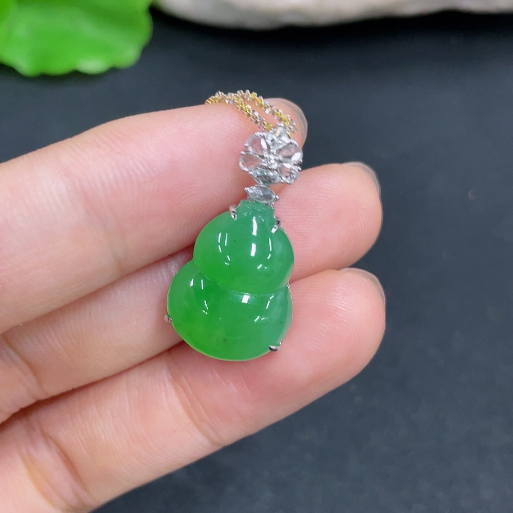Jadeite gourd pendant with 18k gold and diamond accents, displayed on a chain, showcasing intricate inlay work and smooth surface.