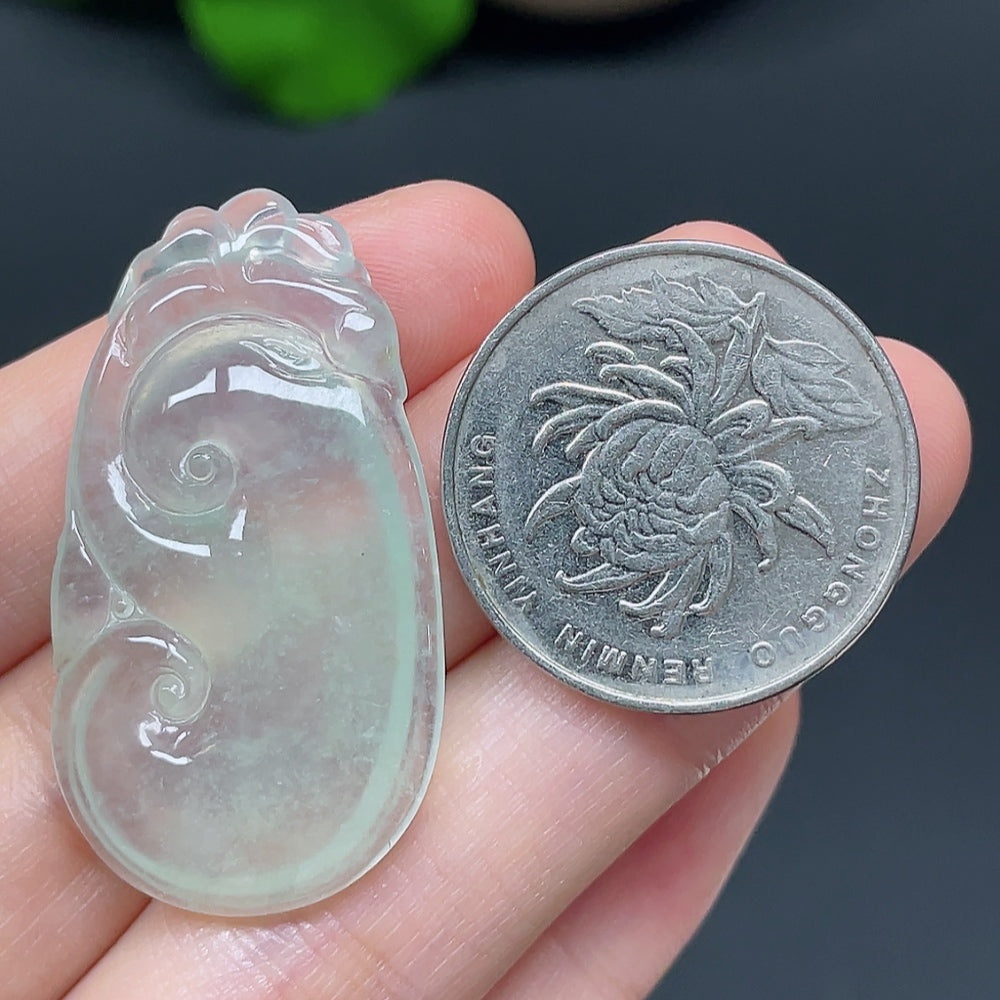 Jadeite Ruyi pendant with intricate carvings, weighing approximately 7.36g, showcasing smooth green jade craftsmanship.