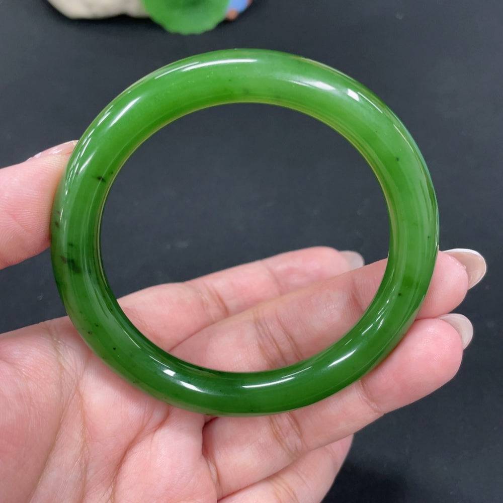 Huiliu certified Hetian jade round bangle showcasing smooth, polished jade surface with natural green and white tones.