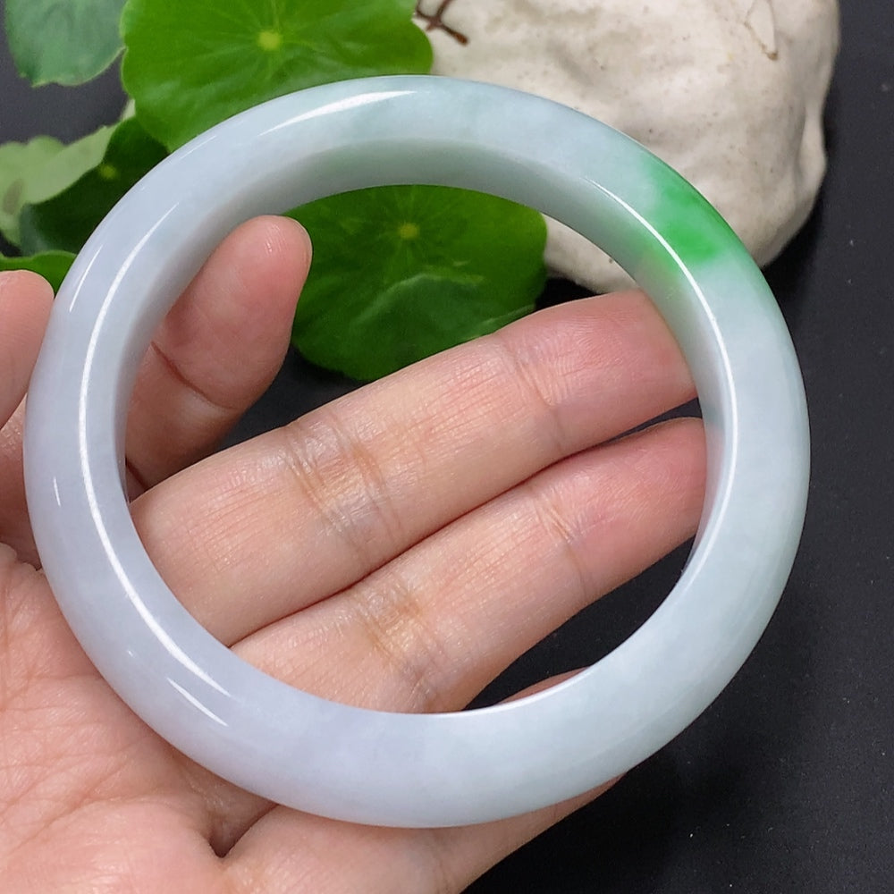 Jadeite round bangle in size 58.8, weighing approximately 68.6g, showcasing smooth green jade with polished finish.