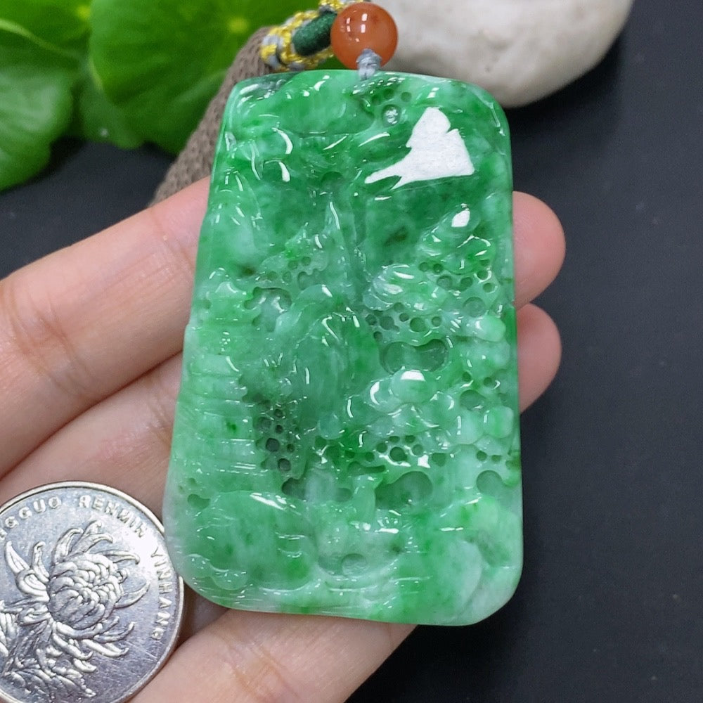 Jadeite landscape pendant by HKHQ featuring intricate jade carving with rope for hanging, weighs approximately 32.6 grams.