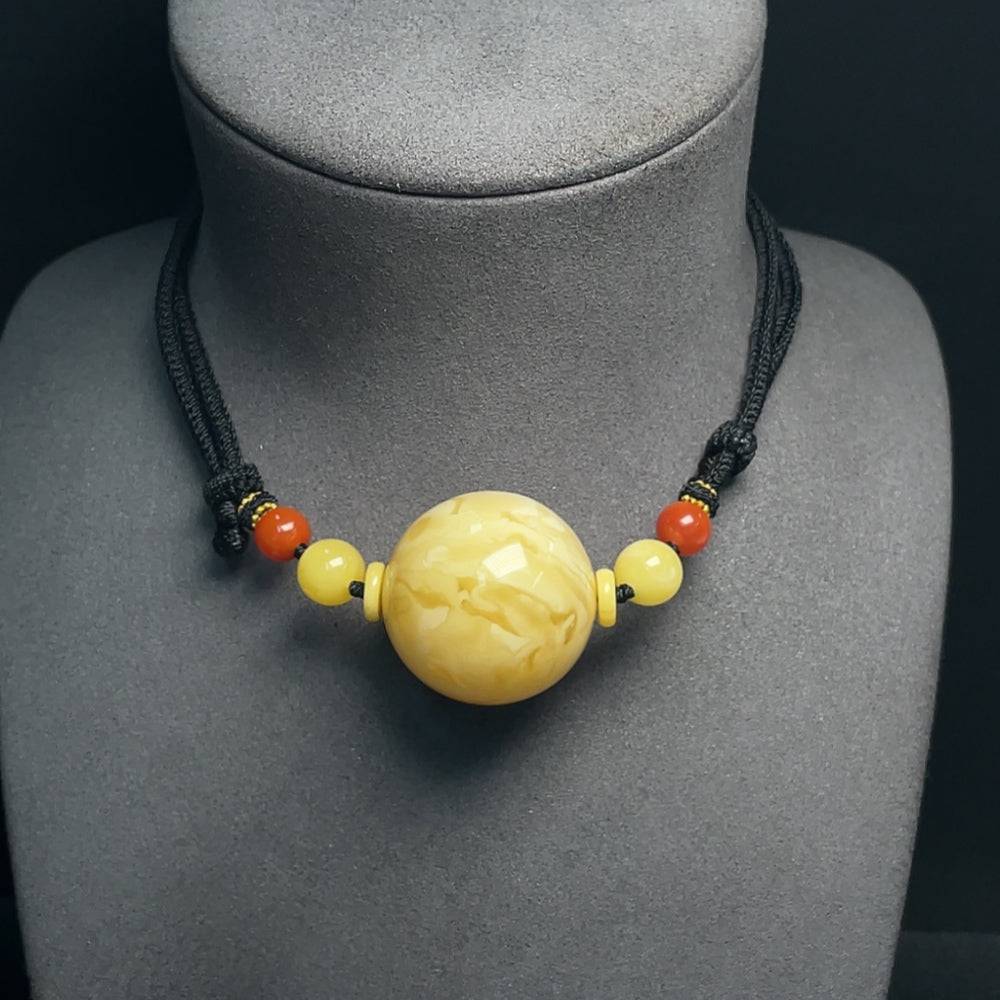 Amber beeswax pendant with Southern Red Agate and rope, 33mm, crafted by HUILIU HQ, showcasing natural amber and red agate stones.