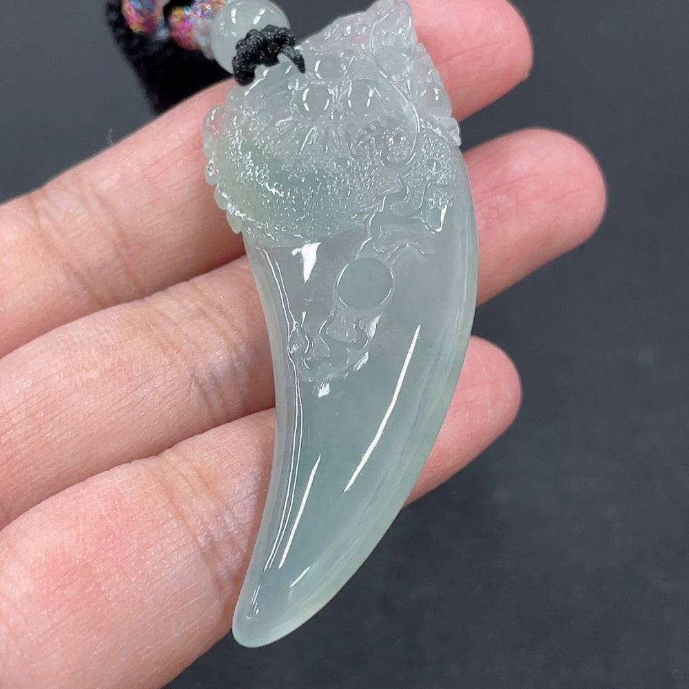 Huiliu Jadeite pendant featuring a dragon tooth design on a rope, certified jade jewelry with intricate craftsmanship.