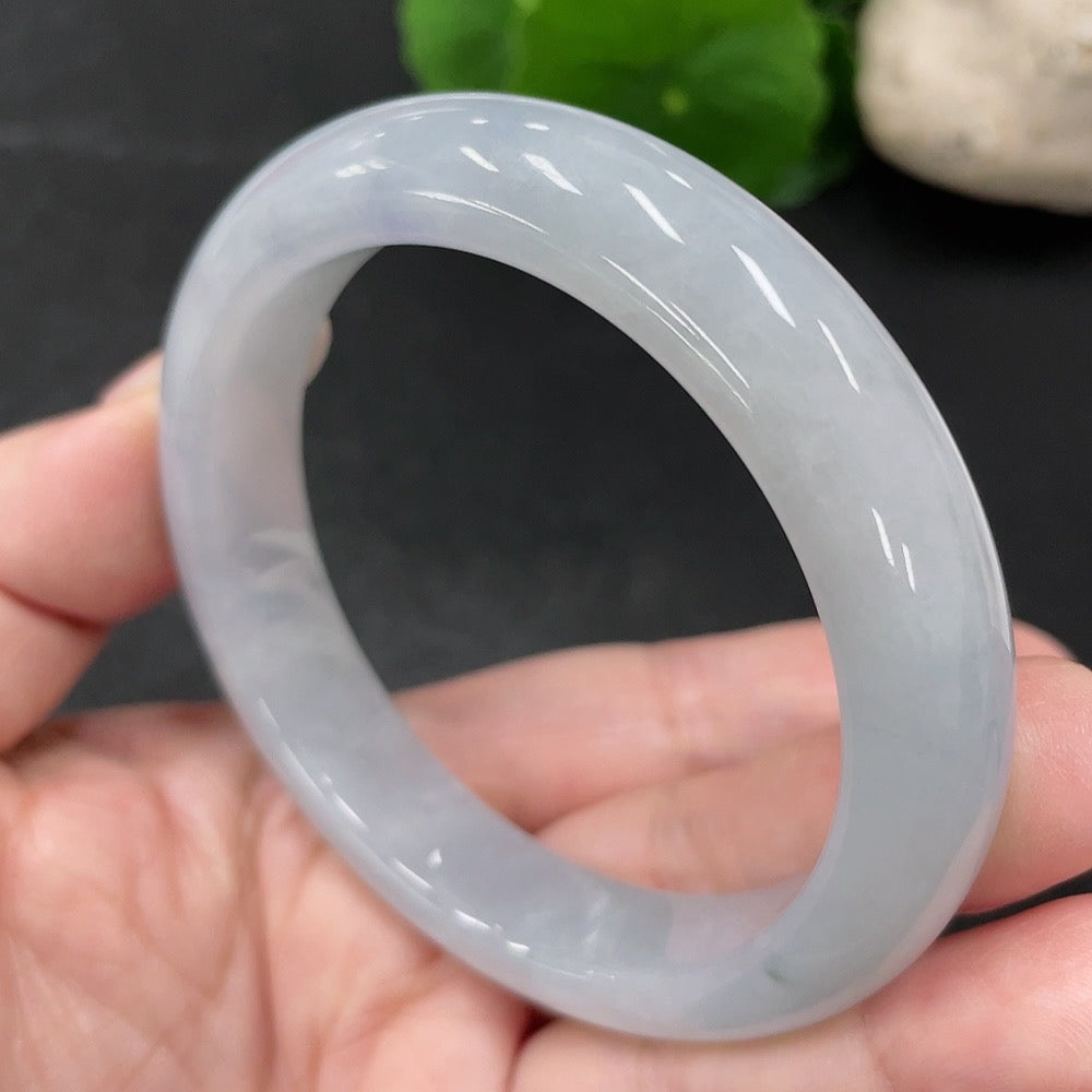 HUILIU HQ jadeite round bangle, size 55.7, weighing approximately 57.52 grams, showcasing smooth, polished jade surface.