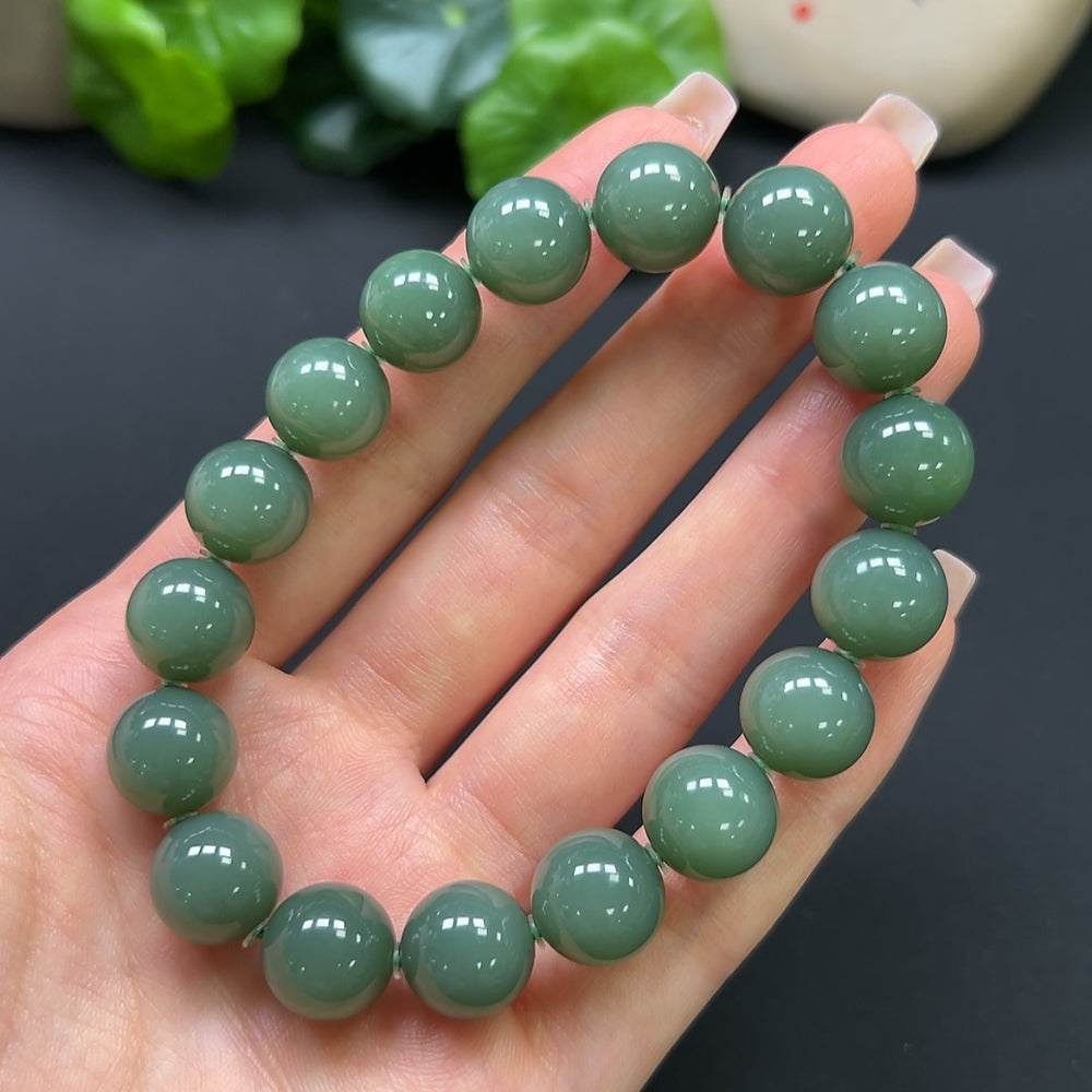 HKHQ Hetian Jade bracelet weighing 45g with smooth, polished green jade beads on a delicate elastic band.