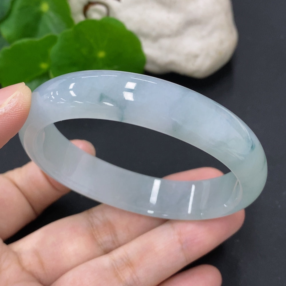 HKHQ jadeite oval bangle in size 56, weighing 43.7g, showcasing smooth, polished green jadeite with elegant oval shape.