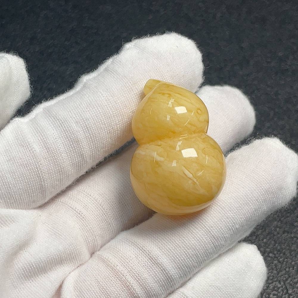 Huiliu HQ Amber Beeswax Jewelry featuring natural amber beads and intricate craftsmanship on a neutral background.