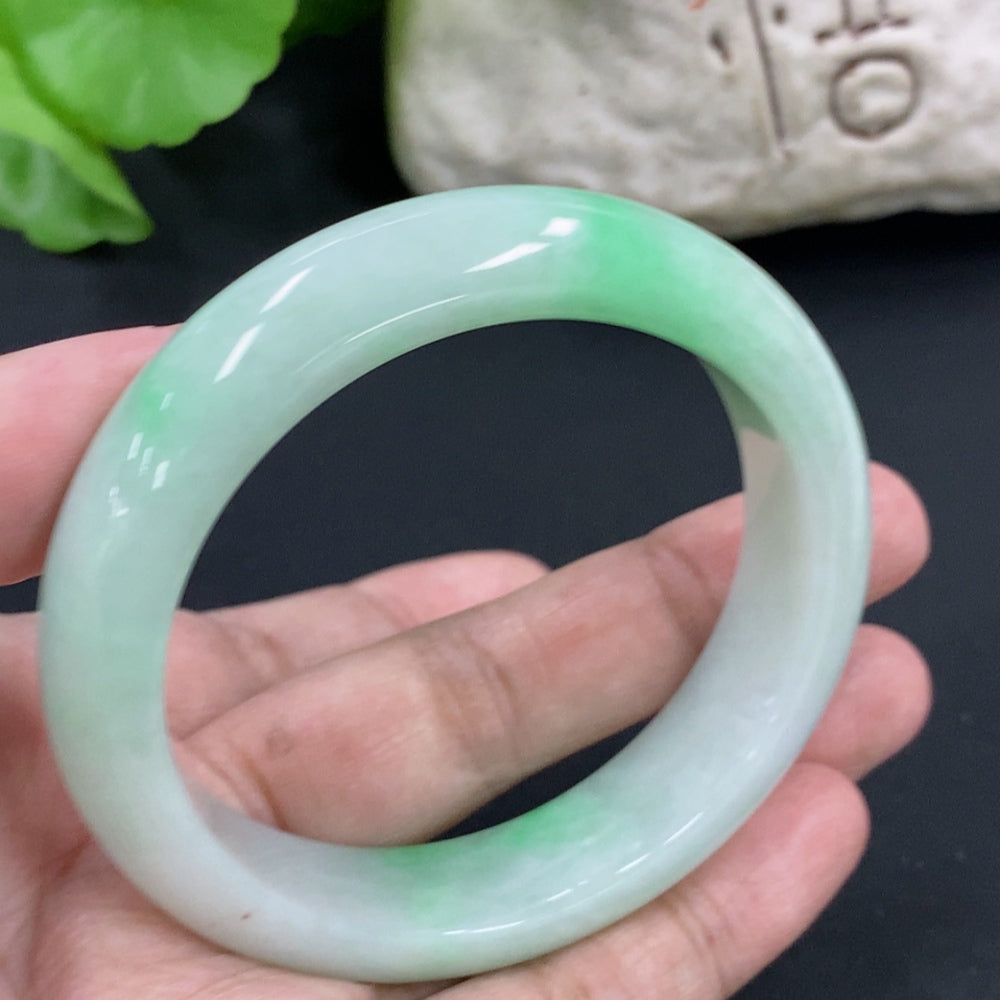 HKHQ jadeite round bangle in size 53.8, showcasing smooth, polished green jadeite with a rounded shape and elegant finish.