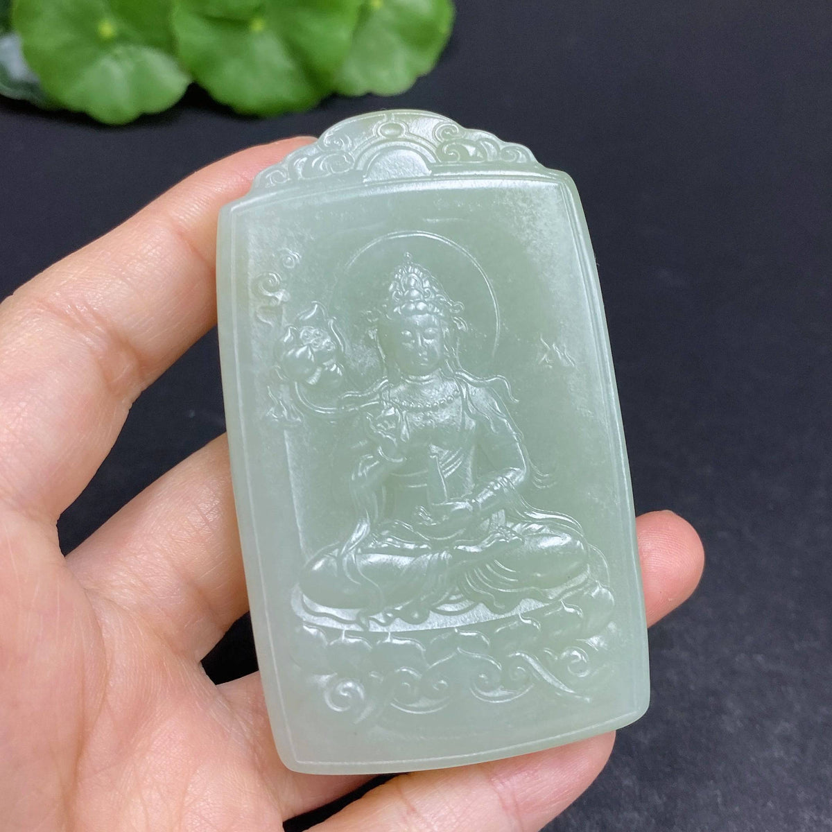 Huiliu certified Hetian jade pendant featuring Guanyin figure, smooth polished surface, with intricate carved details.