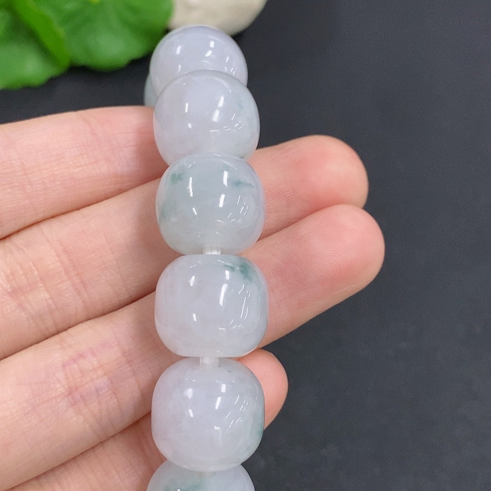 HKHQ jadeite bracelet weighing 83.3g featuring smooth, polished jadeite beads on a flexible string for elegant wrist wear.
