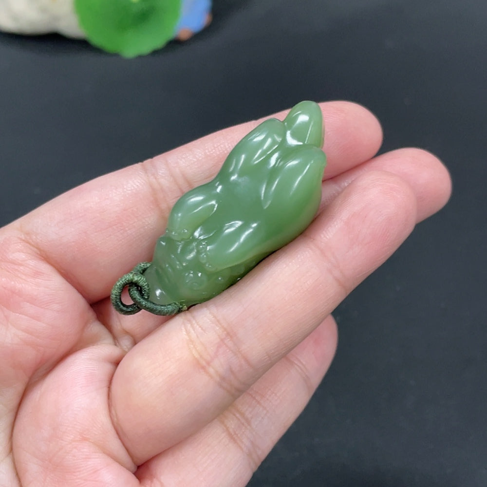 Huiliu certified Hetian jade pendant featuring an auspicious beast carved in smooth, polished jade with intricate details.
