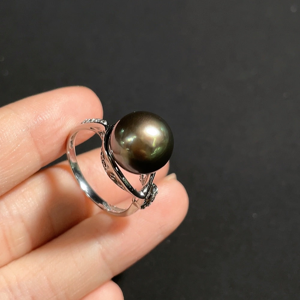 Seawater pearl ring with diamond accents in 18k gold, size 16, featuring a 10.8mm pearl and delicate diamond details.