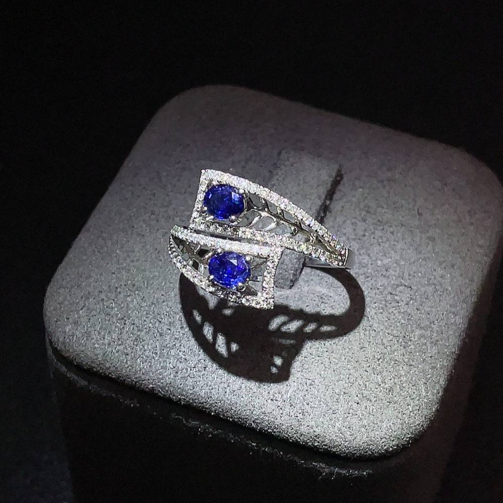 Huiliu sapphire ring with diamond accents, showcasing a vibrant blue gemstone and sparkling diamonds on a silver band.