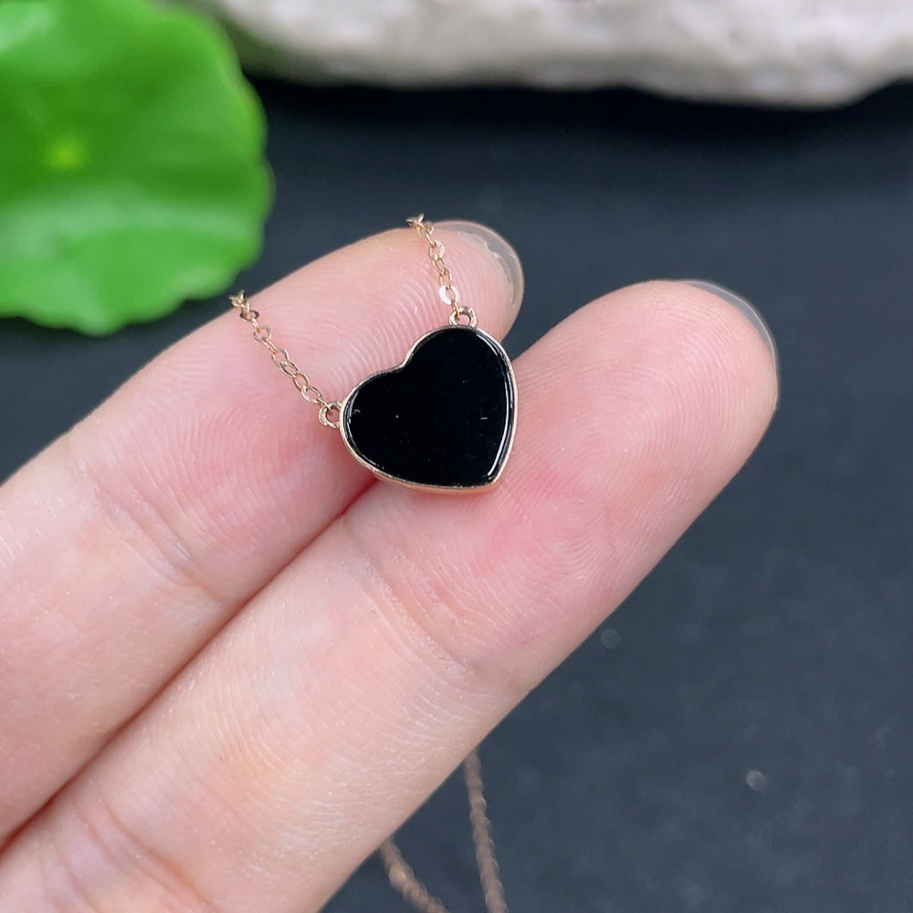 Jadeite heart pendant with inlaid design, 18k chain, HKHQ brand, featuring a smooth, polished jade heart with intricate detailing.