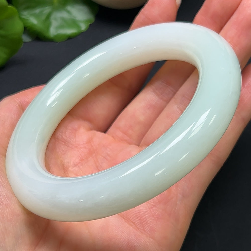 Elegant Hetian Jade round bangle bracelet by HKHQ, size 61.5 with a smooth polished finish and natural jade color.