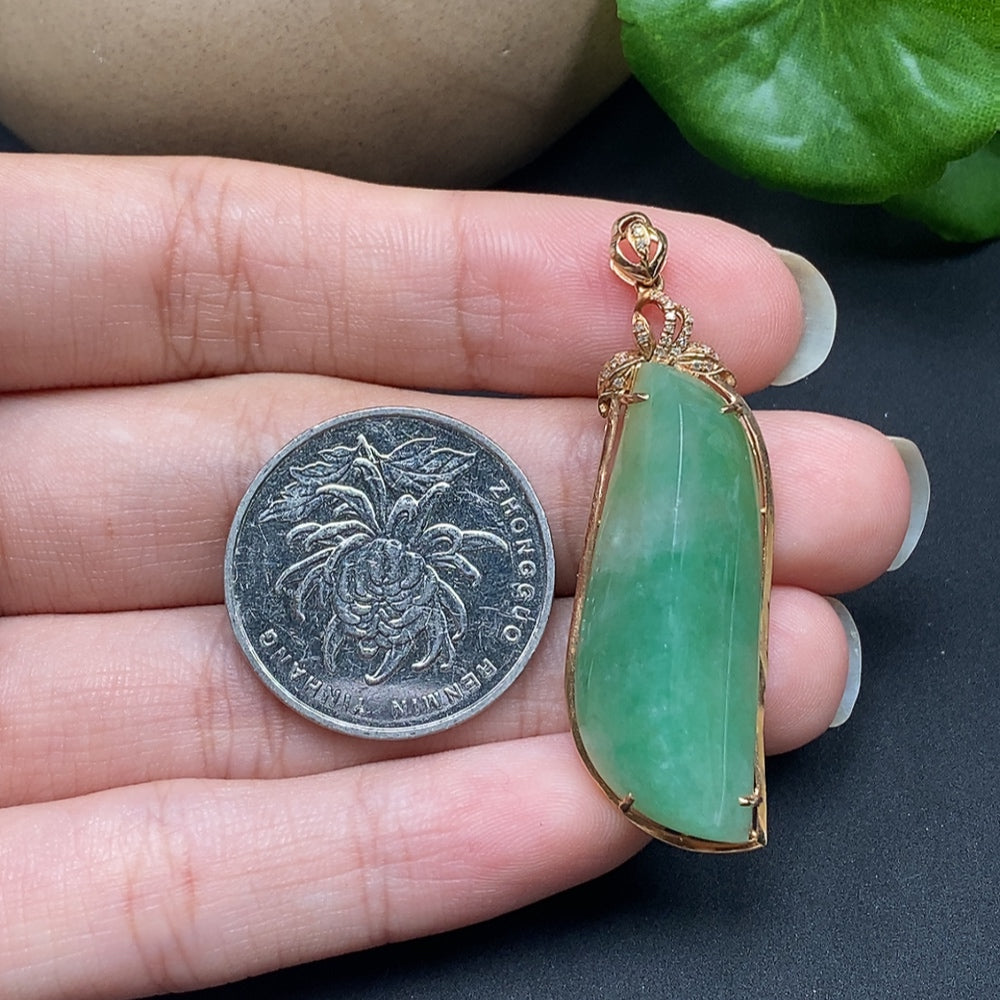 Jadeite inlaid pendant with diamond accents on an 18K necklace, showcasing intricate craftsmanship and elegant design.