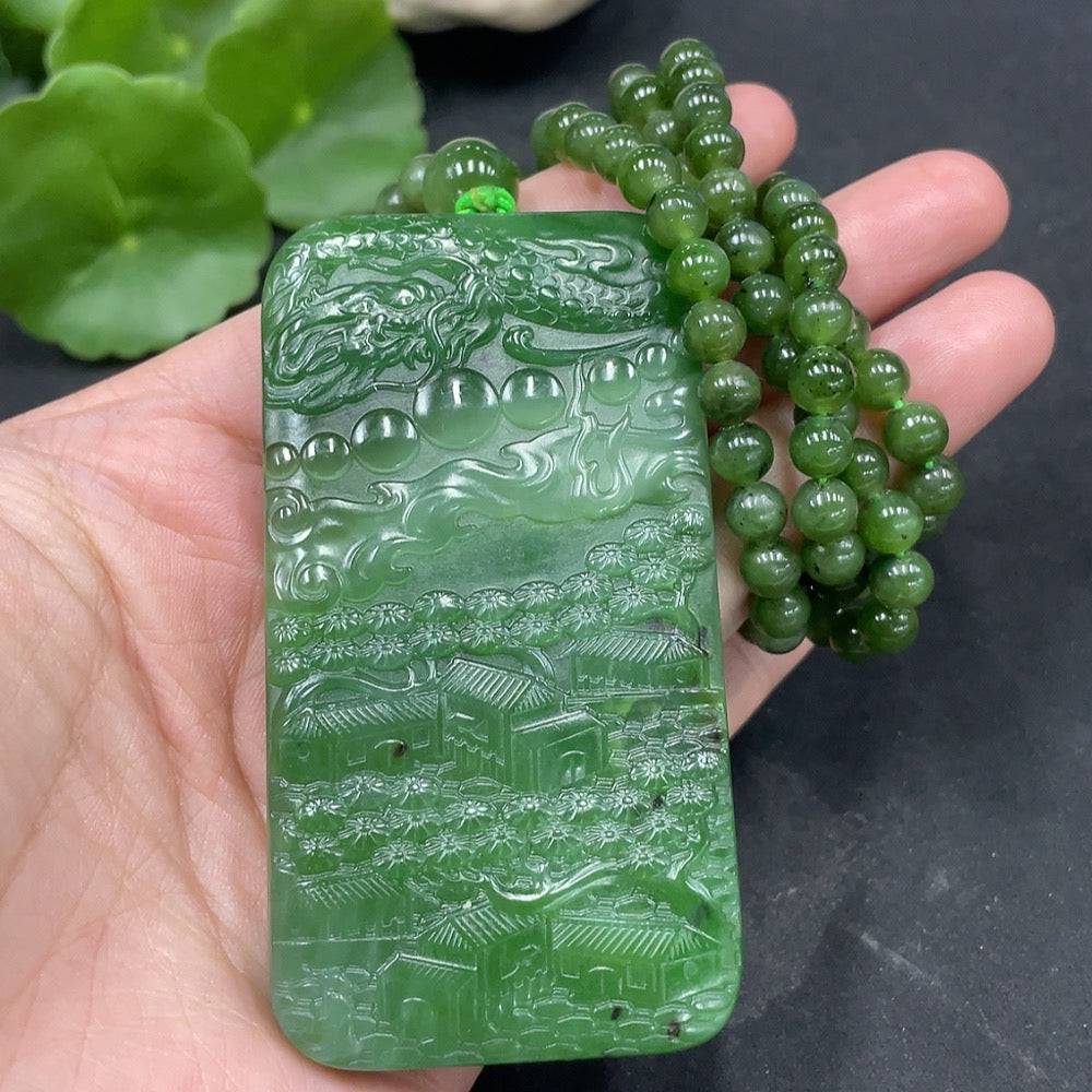 Huiliu Hetian jade Buddha pendant observing the world, intricately carved, showcasing detailed craftsmanship and smooth green jade surface.