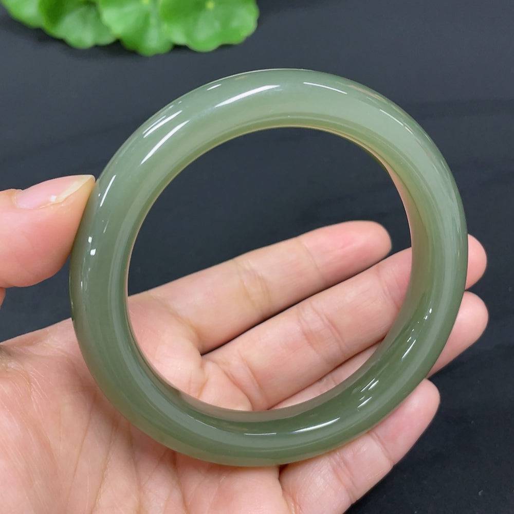 Huiliu certified Hetian jade round bracelet featuring smooth, polished green jade beads on a simple elastic cord.