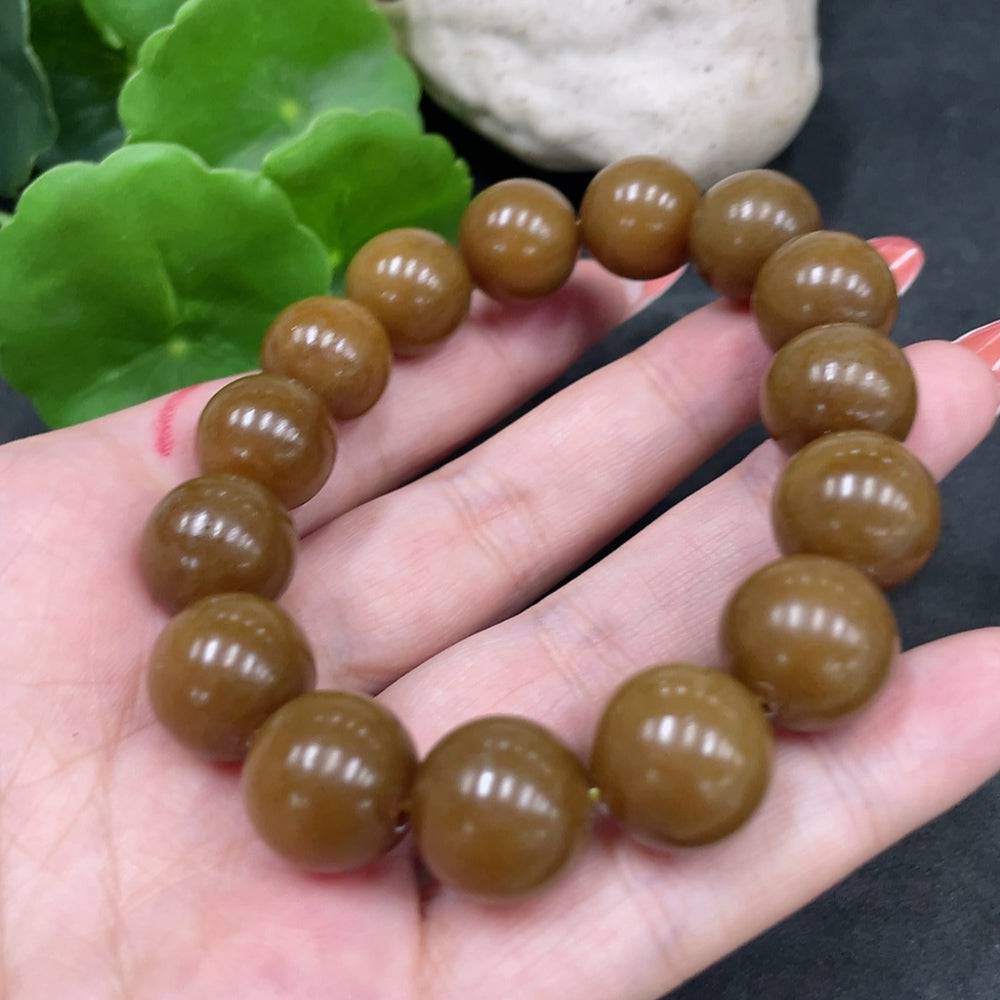 Huiliu certified Hetian Jade bracelet with 13.6mm smooth, polished jade beads, showcasing elegant craftsmanship.