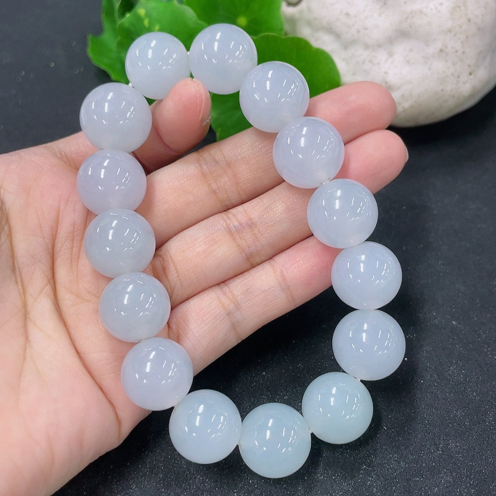 Jadeite bracelet with 15.4mm beads from HKHQ, showcasing smooth, polished green jadeite stones on a delicate bracelet.