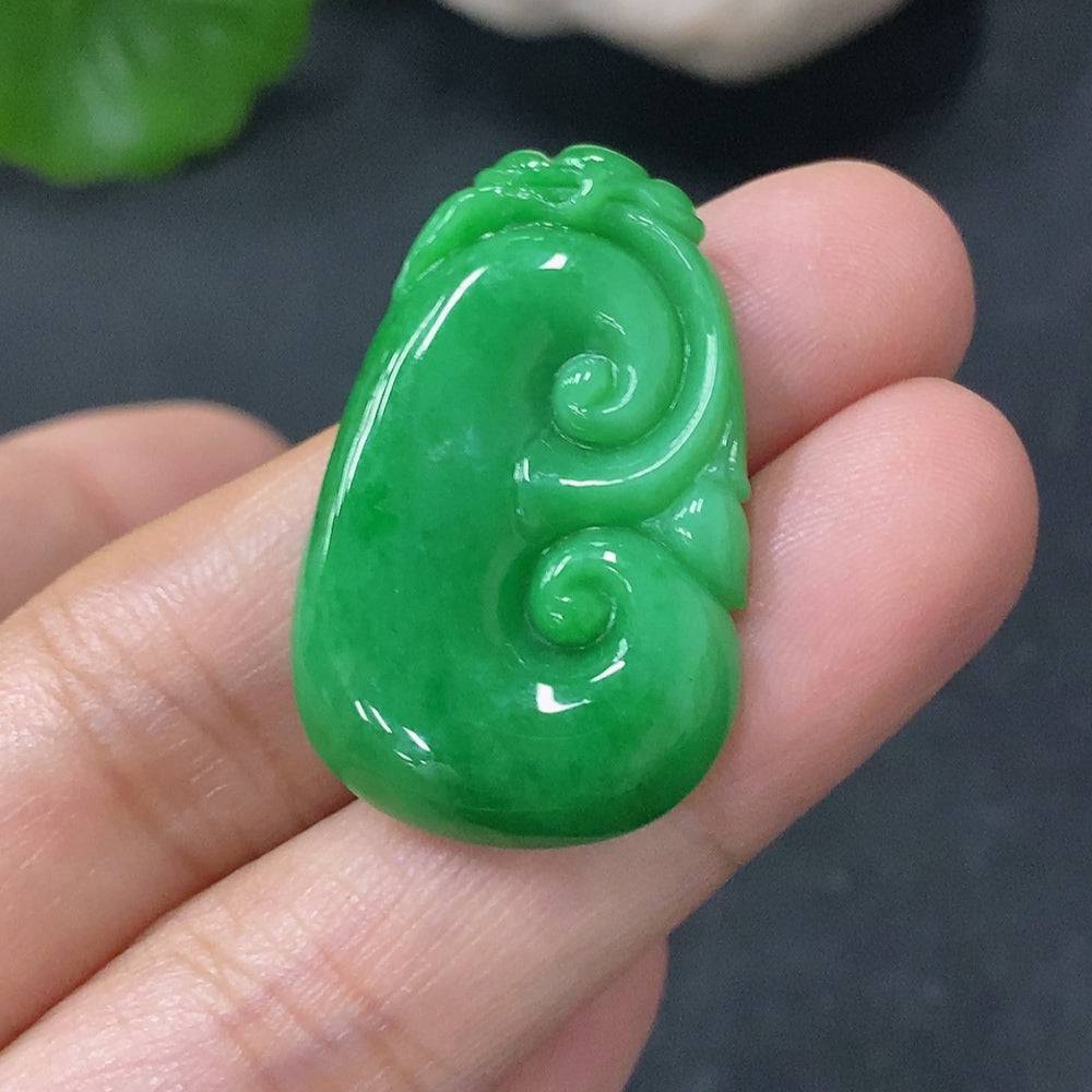 Huiliu Jadeite Pendant Ruyi featuring intricate carved design, glossy green jade with smooth polished surface.