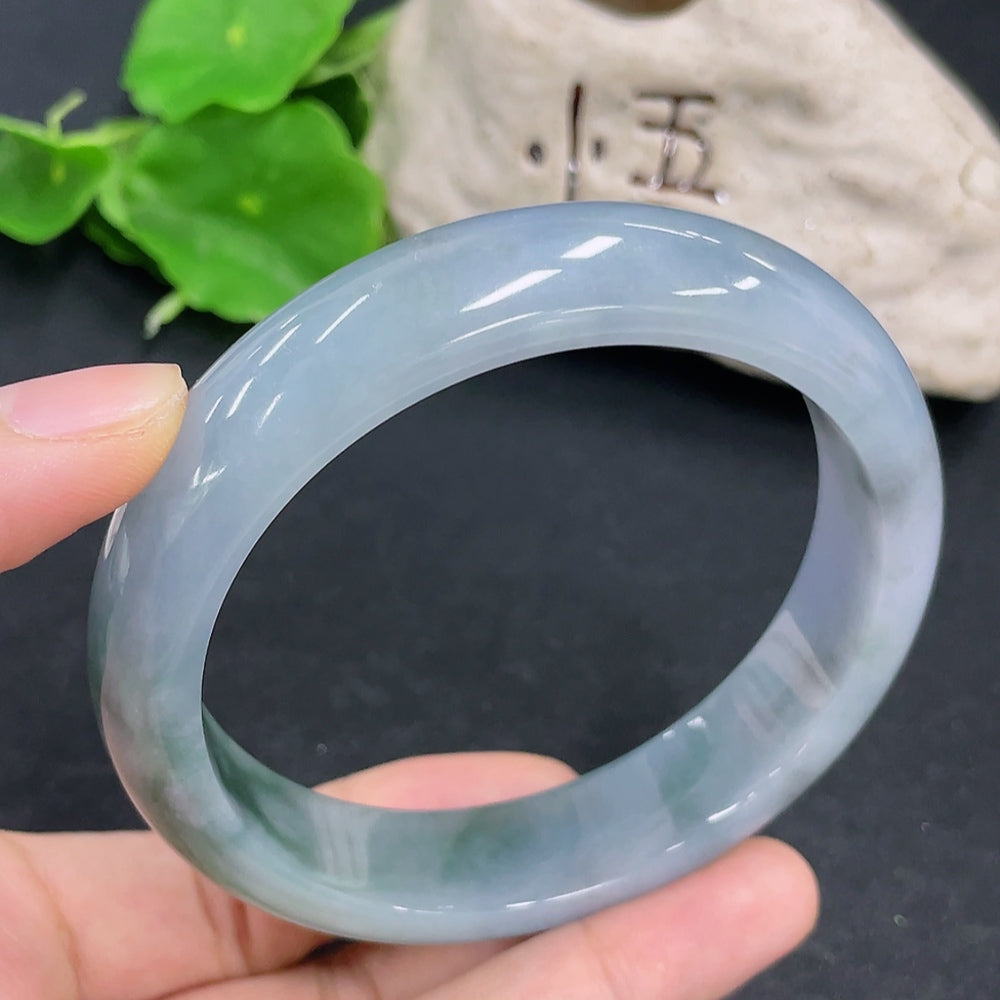HKHQ jadeite round bangle in size 65, showcasing its smooth, glossy surface and rich green color with a weight of 83.3g.
