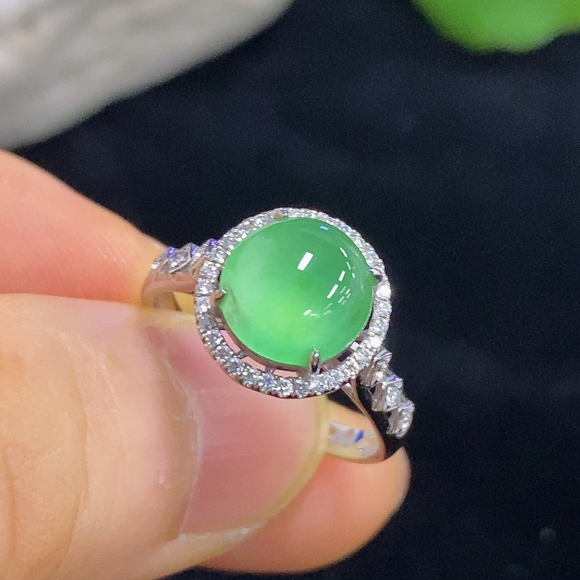 HKHQ jadeite cabochon ring with 18K gold and diamond accents, showcasing a detailed close-up of the inlaid jewelry design.