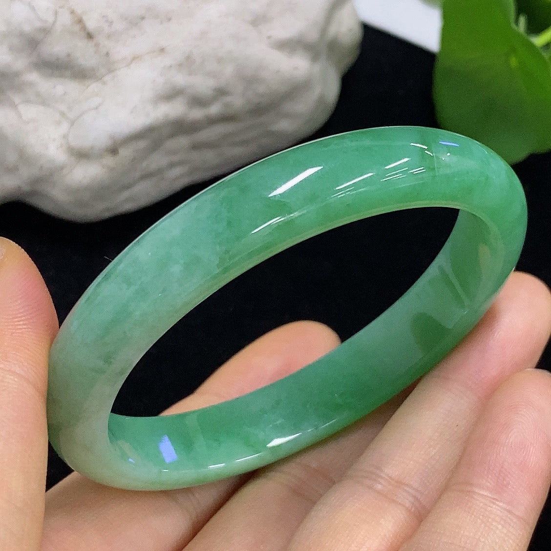HKHQ jadeite oval bangle in size 56.2, weighing 38.3g, featuring a smooth polished surface and elegant oval shape.