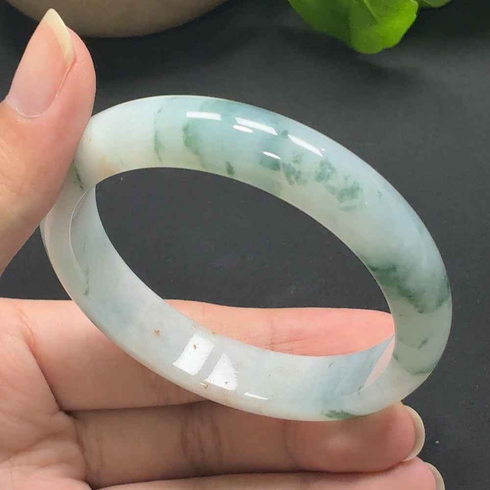 Jadeite round bangle in size 56.4, weighing approximately 51.68g, showcasing smooth, polished green jade from HKHQ.