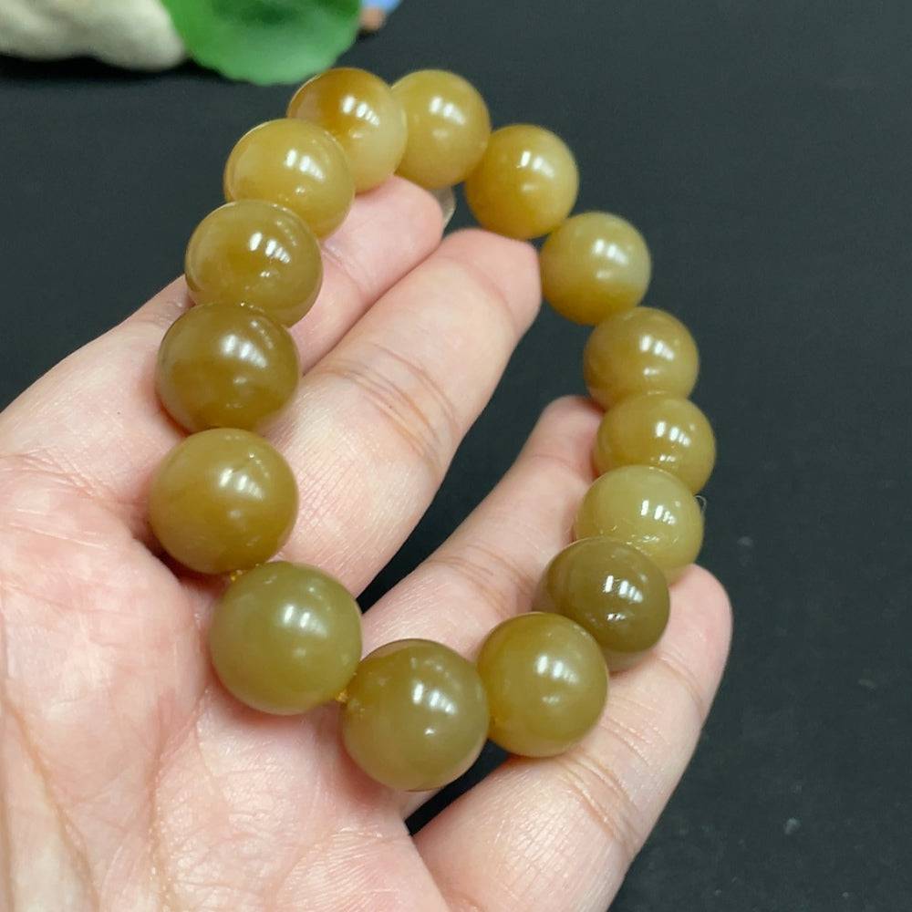 Hetian jade bracelet by HUILIU HQ with 13.9mm beads, weighing approximately 65.4 grams, featuring smooth polished jade stones.