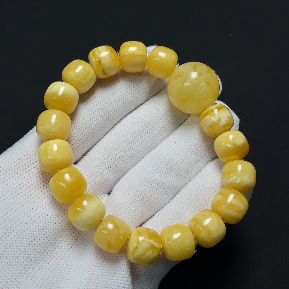Amber beeswax bracelet by HKHQ with visible repairs, weighs approximately 19.22g, size 11.4-18.8mm, natural amber color.