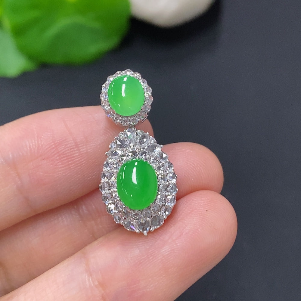 Jadeite cabochon pendant with diamond accents in 18K gold, showcasing smooth green jade and sparkling diamond details.