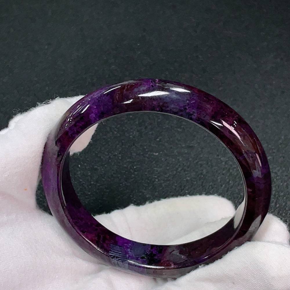 Sugilite gemstone bracelet with purple stones and mineral components, approximately 57.8mm in size, weighing 51.6g.