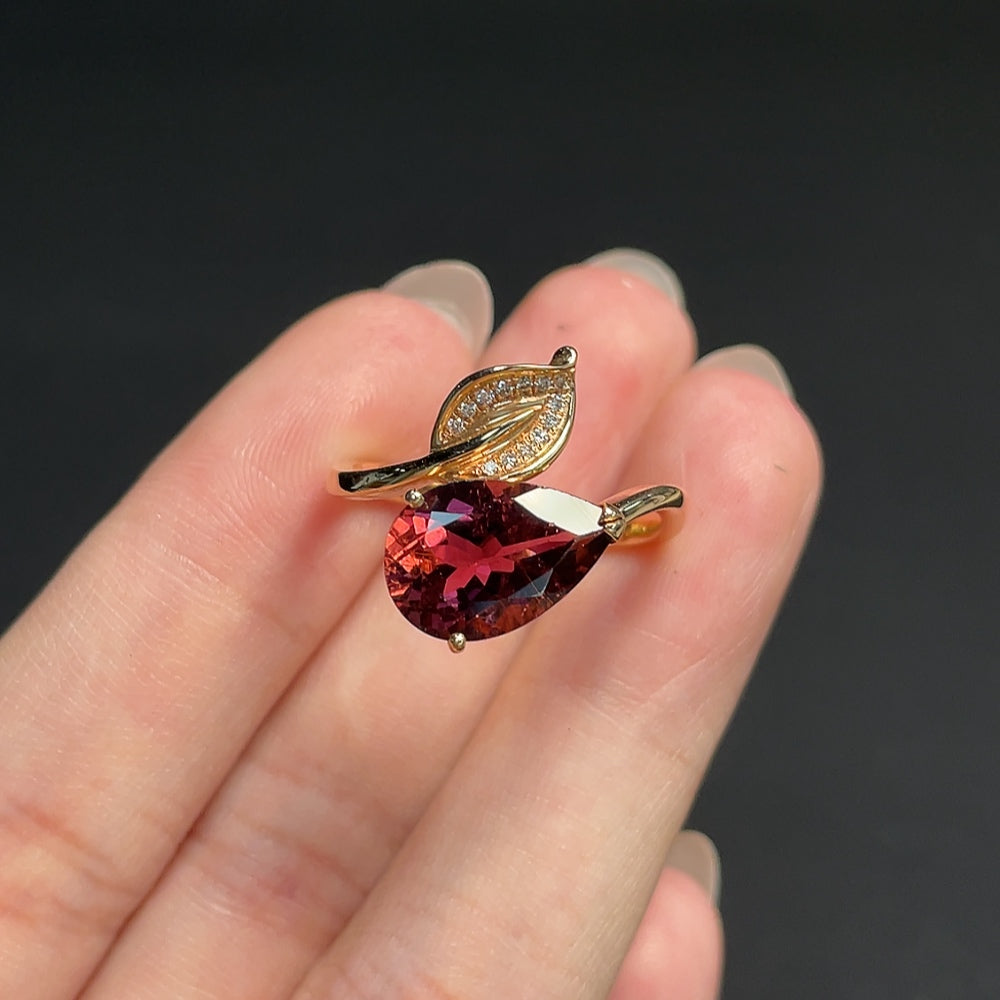 18K gold tourmaline ring with diamond accents, adjustable, featuring vibrant gemstones and elegant design.
