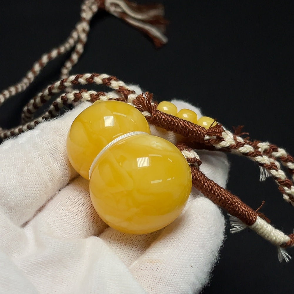 Amber Beeswax Pendant necklace featuring a warm, natural beeswax pendant with a silver bail on a delicate chain.