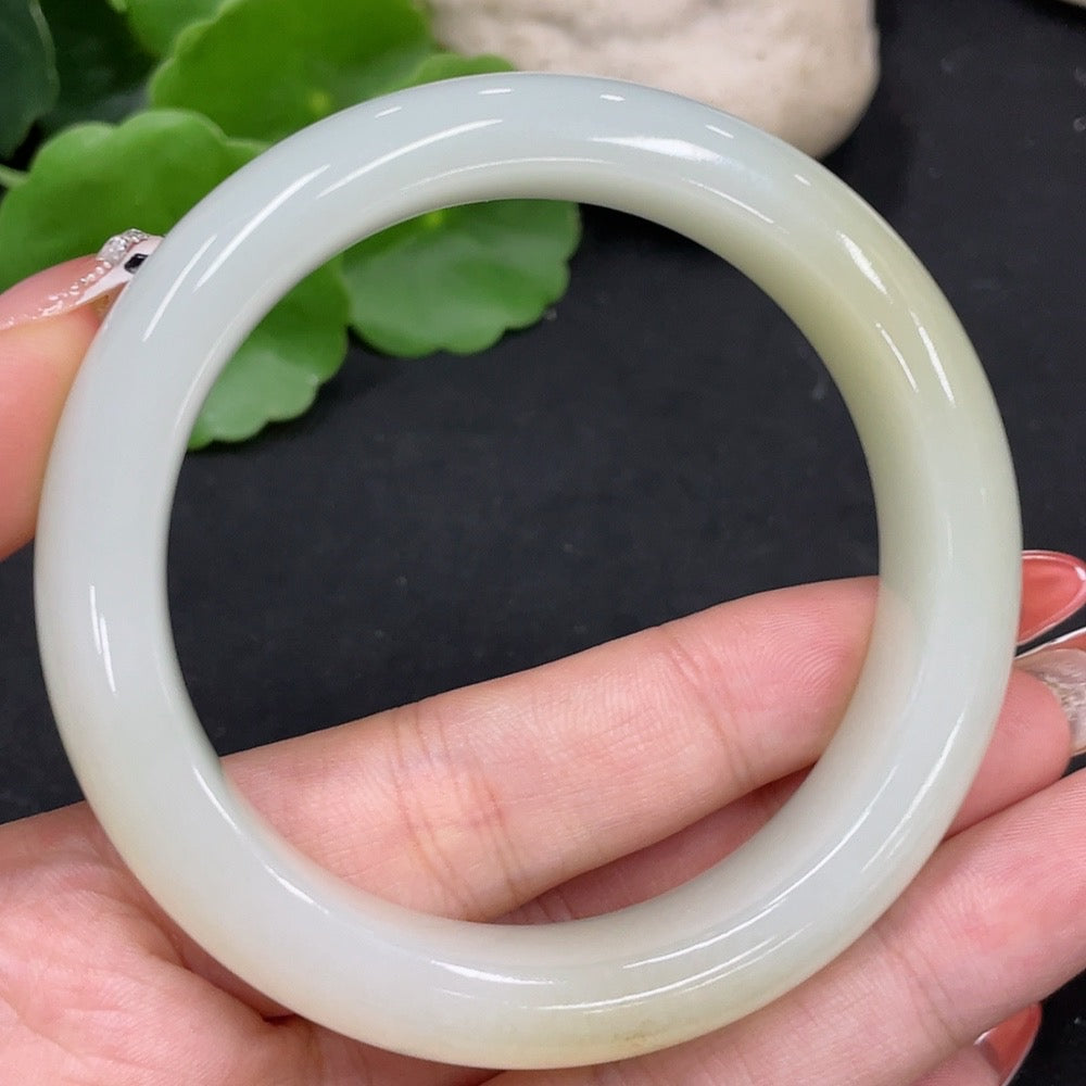 Round Hetian jade bangle by HUILIU HQ with size 55.1 and weight 58.4g, showcasing smooth, polished jade surface and elegant design.
