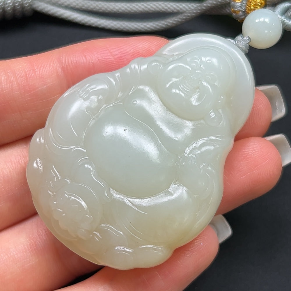 Hetian jade Buddha pendant weighing 50.54g with rope, showcasing smooth, polished jade and detailed Buddha carving.