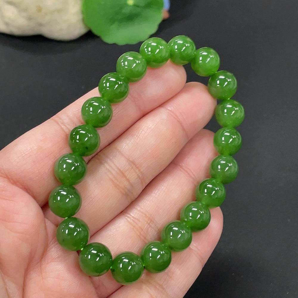 Hetian Jade bracelet with 9.5mm beads, weighing approximately 28.6g, from HUILIU HQ, showcasing smooth, polished jade stones.