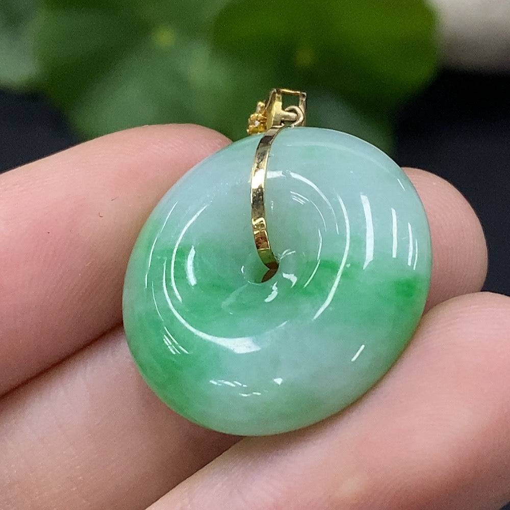 Jadeite safety buckle pendant with 18K gold accents and diamond details, featuring a smooth jade surface and intricate craftsmanship.