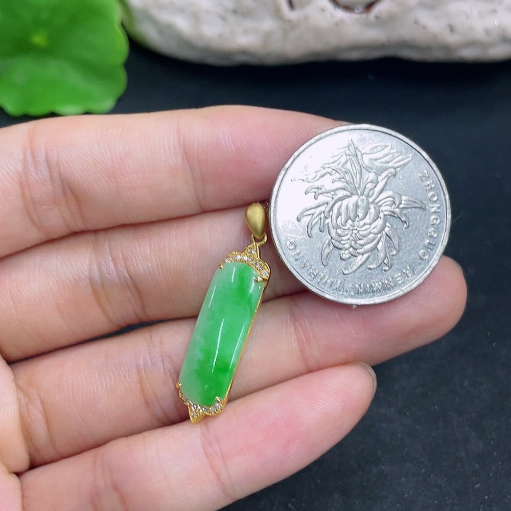 Jadeite pendant with 18K gold and diamond accents, showcasing a polished green gemstone on a delicate chain.