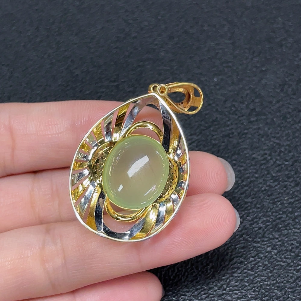 Prehnite pendant necklace with 18K gold and diamond accents, featuring a polished green gemstone and intricate gold setting.