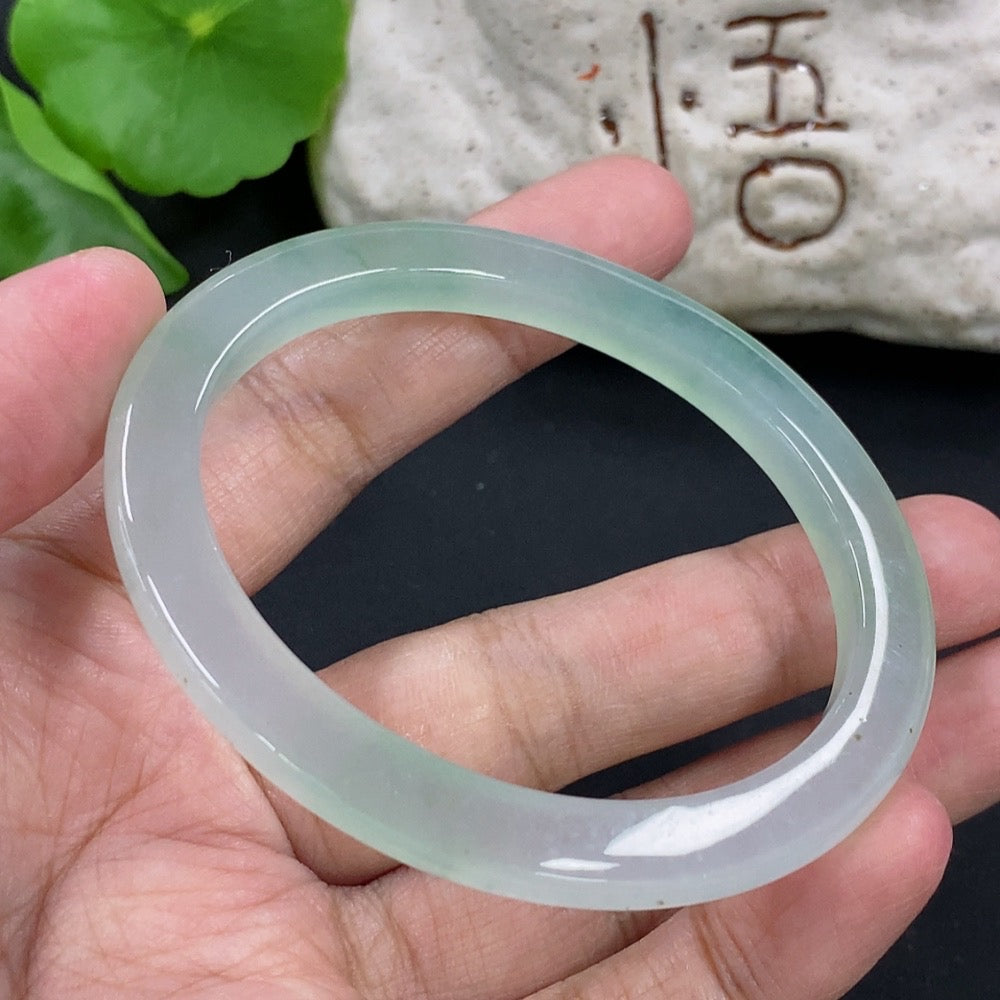 HKHQ jadeite oval bangle, size 55.3, weighing 24.3g, showcasing smooth, polished green jadeite with elegant oval shape