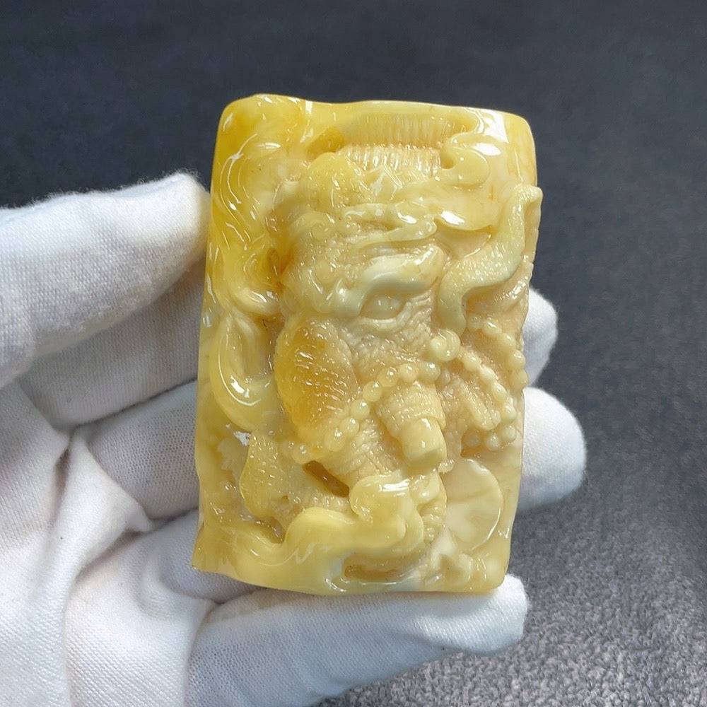 Huiliu Amber Beeswax Pendant jewelry featuring a natural amber stone with intricate details and warm golden hues.