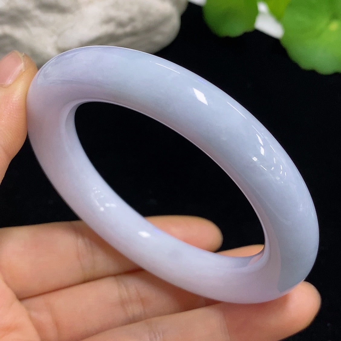 HKHQ jadeite round bangle in size 54.5 with a smooth polished surface, showcasing vibrant green jadeite detail.