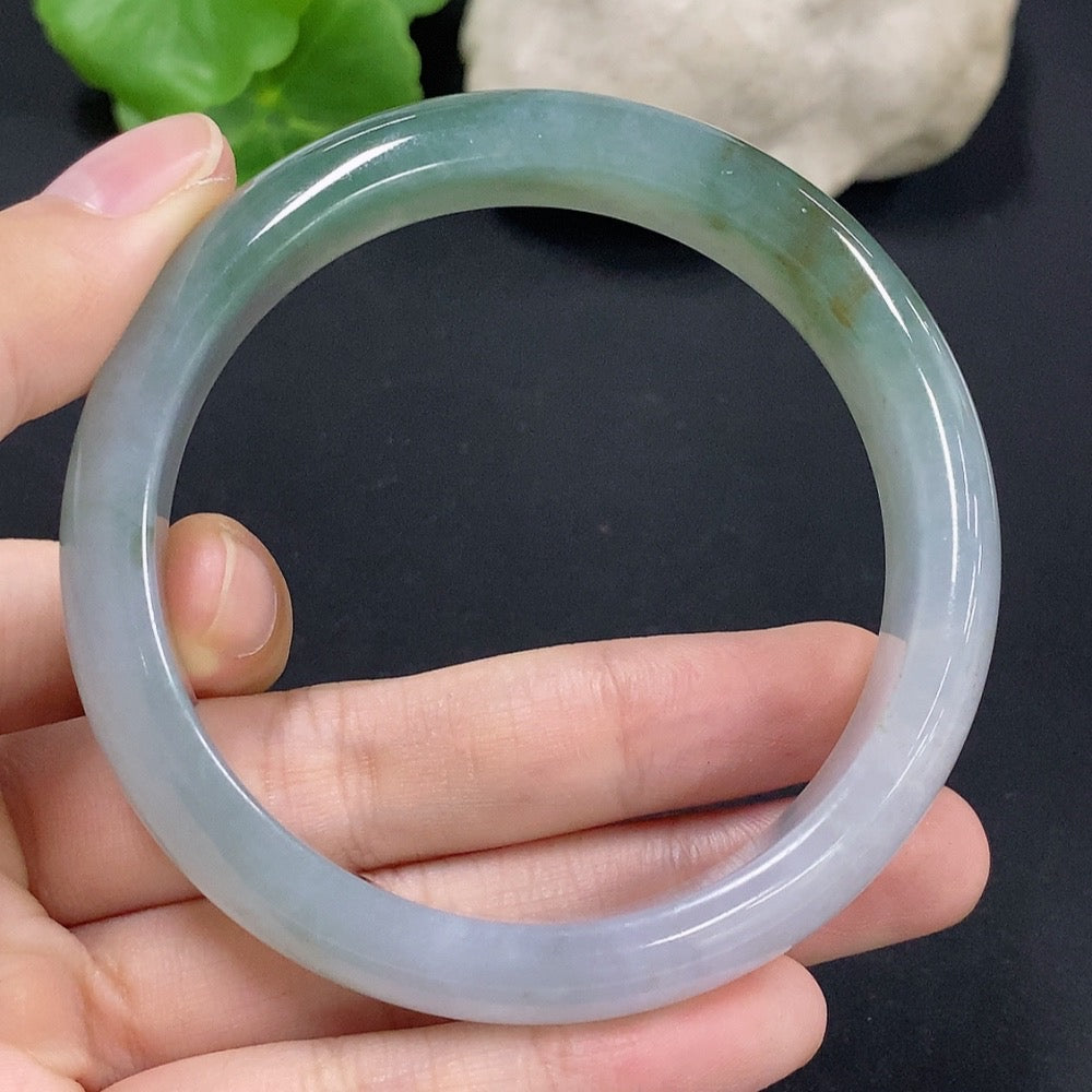 Jadeite round bracelet by HKHQ with a size of 57.9, repaired, weighing approximately 55.38g, featuring polished jade stones.